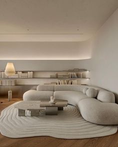 a modern living room with white furniture and bookshelves