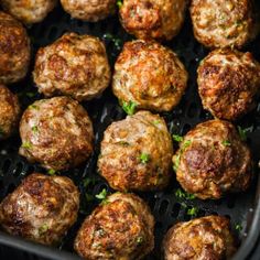 cooked meatballs in an air fryer with parsley on top, ready to be eaten