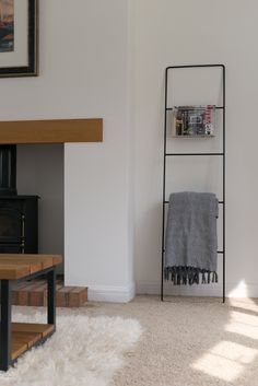 a living room with white walls and carpet