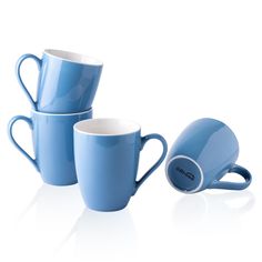 three blue coffee mugs sitting next to each other on a white surface with one cup in the middle