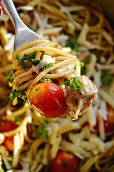 a fork full of pasta with meat and vegetables