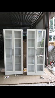 two white glass doors sitting inside of a building