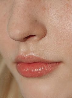 a woman's face with freckles on her cheeks and nose, close up