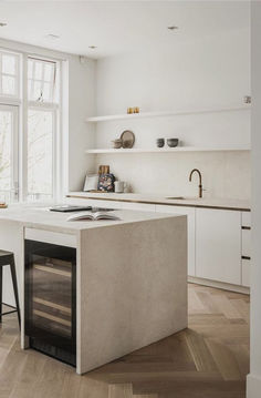 an island in the middle of a kitchen with two stools