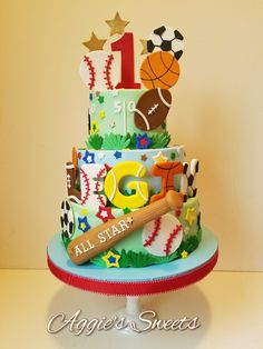 a three tiered cake with sports themed decorations