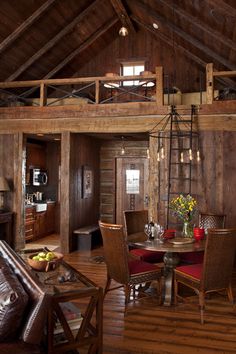 a living room filled with furniture and wooden walls