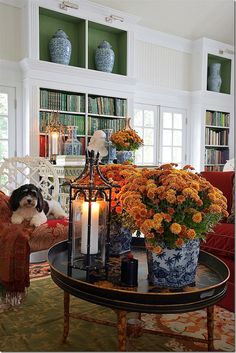 a living room filled with lots of furniture and flowers