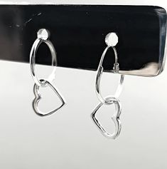 Add a touch of timeless sophistication to your jewelry collection with our exquisite 925 Sterling Silver Heart Hoop Earrings. Crafted with precision and love, these earrings feature a beautifully delicate design measuring 15/32 inches in width and 25/32 inches in length, perfectly capturing the essence of minimalist elegance. Stamped with the 925 hallmark, these heart hoop earrings guarantee the highest quality of sterling silver, ensuring they remain a cherished piece for years to come. Made for both everyday wear and special occasions, these sterling silver heart hoops are incredibly versatile. Whether you're dressing up for a romantic dinner or adding a subtle sparkle to your casual outfit, these earrings will effortlessly elevate your look. The secure clasp ensures they stay in place, Pierced Hoop Heart Earrings For Anniversary, Pierced Open Heart Hoop Earrings For Anniversary, Hypoallergenic Hoop Earrings For Valentine's Day Anniversary, Anniversary Open Heart Pierced Hoop Earrings, Anniversary Open Heart Hoop Earrings, Sterling Silver Hoop Jewelry For Valentine's Day, Minimalist Silver Hoop Earrings For Valentine's Day, Silver Hoop Jewelry For Valentine's Day, Anniversary Heart Charm Hoop Earrings