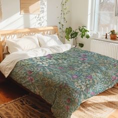 a bed sitting in a bedroom next to a window with plants on top of it