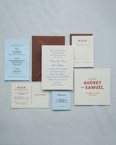 the wedding stationery is laid out on top of each other