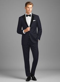 A show-stopper looks on a regular day will be a fabulous addition to your wardrobe. Tailored with a blend of wool and lycra, our Napolean Stretch Navy Blue Wool Tuxedo Suit is a stunning piece that has a smooth finish and can prove to be a great fit for your modern lifestyle. It's a versatile suit that will look fancy in cold weather and be a trendsetter in the fashion world.  Featuring satin lapel, matching satin covered buttons and gentle texture at its surface, our tuxedo is a subtle fashion- Fitted Wool Tuxedo With Long Sleeves, Fitted Long Sleeve Tuxedo, Fitted Wool Blazer For Black-tie Events, Fitted Wool Tuxedo Suit, Fitted Wool Tuxedo With Pressed Crease, Fitted Wool Suit For Evening, Fitted Wool Suits For Evening, Elegant Fitted Wool Tuxedo, Fitted Wool Tuxedo For Business