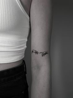 a woman's arm with three birds tattoo on the left side of her arm