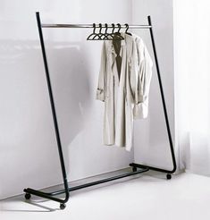 a clothes rack with two shirts hanging on it's sides and an open jacket hanger