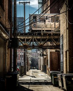 a train is going down the tracks in an alley