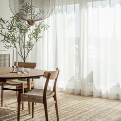 a dining room table with chairs and a vase on it