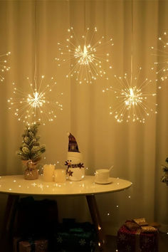 a table topped with a cake covered in white frosting next to christmas trees and presents