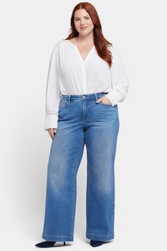 The Teresa Wide Leg Jeans in Plus Size with 1 1/2" Hems by NYDJ don’t just stand out—they steal the show. Their wide legs add instant polish to everything you pair them with. Our Lift Tuck® Technology is made to help you keep your shape, with a proprietary slimming panel with a patented criss-cross design that smooths and sculpts. Features five-pocket styling and a zip fly with button closure. Water Canyon is a vintage-inspired medium indigo wash with whiskering on the front hips, inseam chevrons and sanding on the front thighs, knees and seat. This jean is made with earth-friendly methods that result in reduced consumption of water, chemicals and/or energy. | NYDJ Women's Teresa Wide Leg Jeans In Plus Size in Water Canyon, Size: 22W | Denim Cross Design, Wide Legs, Petite Outfits, Earth Friendly, Jeans For Sale, In Water, Sanding, Workout Tops, Wide Leg Jeans