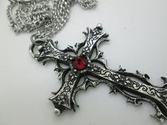 This Gothic cross necklace is an handmade pewter sculpture orned with an Austrian Swarovski or a real gem (My fav is the Black star Diopside, seriously) This gothic necklace is sold with a stainless steel chain of 18'' or 24'', if you would like to have a different length for the chain, you can write the desired length in the private note section when ordering :) This is a Gothic cross of 7cm This gothic cross necklace is a pewter sculpture of my own creation, i create and work the metal by myse Medieval Jewelry For Halloween Gift, Silver Cross Jewelry For Halloween, Medieval Engraved Cross Jewelry, Gothic Ankh Jewelry For Gift, Gothic Cross Pendant Jewelry Gift, Gothic Cross Jewelry As Gift, Gothic Cross Jewelry Gift, Handmade Gothic Cross Pendant Necklace, Gothic Cross Jewelry For Gifts