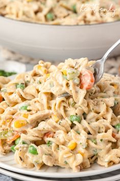 a white plate topped with macaroni salad and a fork