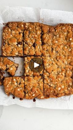 an oatmeal bar cut into squares and placed on top of parchment paper