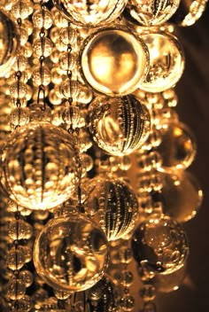 a chandelier with lots of shiny balls hanging from it's centerpiece