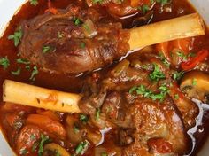 a bowl filled with meat and vegetables covered in gravy