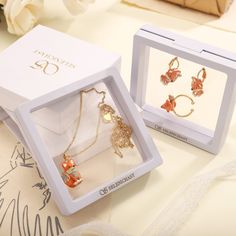 two jewelry sets in a box on a table