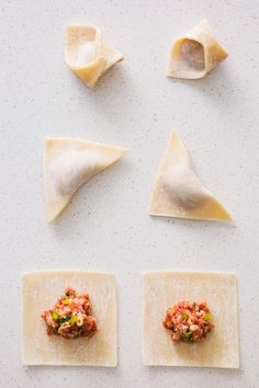 four different types of ravioli on top of a white surface with sauce and seasonings