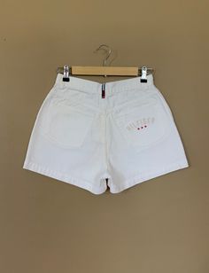 "High waisted 90's denim shorts. Made by Tommy Hilfiger in classic white denim wash with embroidered Tommy Hilfiger logo on back pocket. Shorts are in excellent clean condition with light naturally distressed character. Measurements (taken zipped or buttoned up and laid comfortably flat) inches x 2 for total circumference (inches) Tag Size 10 Tommy Hilfiger 100% Cotton Waist 27\" Hips 42\" Length 13.5\" Inseam 2.5\" Rise 11\" Bottom leg circumference 26\" All items are free of rips, tears, holes Levis Jeans High Waisted, Levi High Waisted Shorts, Tommy Hilfiger 90s, Levis Mom Jeans, 90s Tommy Hilfiger, Tommy Hilfiger Logo, Tommy Hilfiger Shorts, 90s Denim, Pocket Shorts