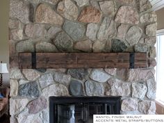 a stone fireplace with wooden mantels in a living room