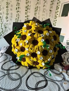 a bouquet of sunflowers on top of a bed