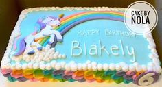 a birthday cake with a unicorn on it and the words baked by nola written in white frosting