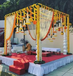 an outdoor wedding setup with orange and white decorations