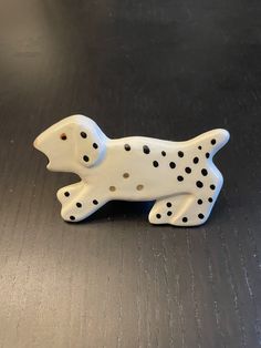 a white and black dalmatian dog figurine on a table