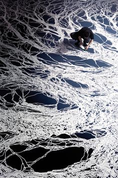 a snowboarder riding down the side of a snowy slope with lots of ice on it