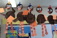 a group of turkeys that are hanging on a bulletin board in a school room