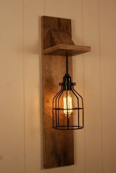 a light that is on the side of a wall with a caged light bulb