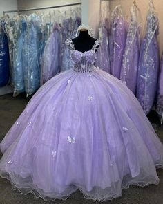 a dress is on display in a room full of other dresses and tulle skirts