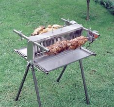 an outdoor grill with food cooking on it