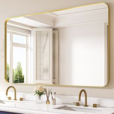 a bathroom with two sinks and a large gold framed mirror on the wall above it