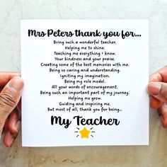 two hands holding up a thank card with the words,'my teacher'written on it