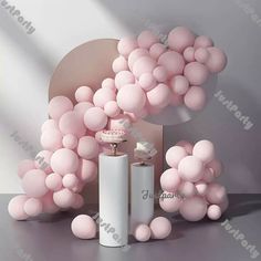 pink balloons are floating in the air next to two white cylinders and a cake