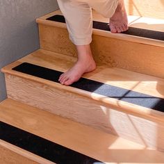 a person walking up some stairs with their feet on the ground