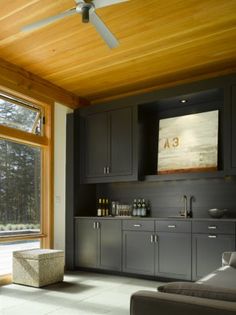 a living room filled with furniture and a flat screen tv mounted to the side of a wall