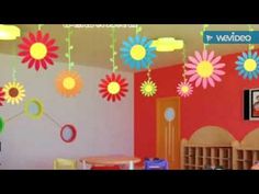 the children's room is decorated in bright colors and has flowers hanging from the ceiling