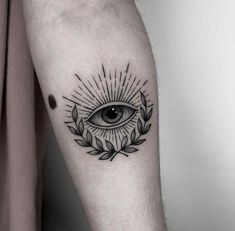 an all seeing eye tattoo on the arm