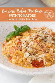 a white plate topped with pasta covered in cheese and tomato sauce, garnished with basil leaves