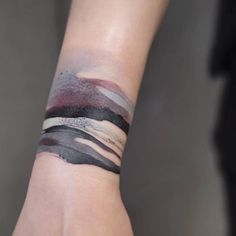 a woman's arm with a wristband that has different colored lines on it