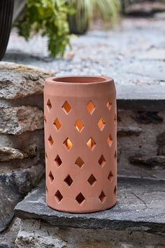 a pink vase sitting on top of a stone step