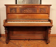 an old wooden piano sitting in a room